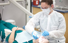 dental hygienist performing dental exam