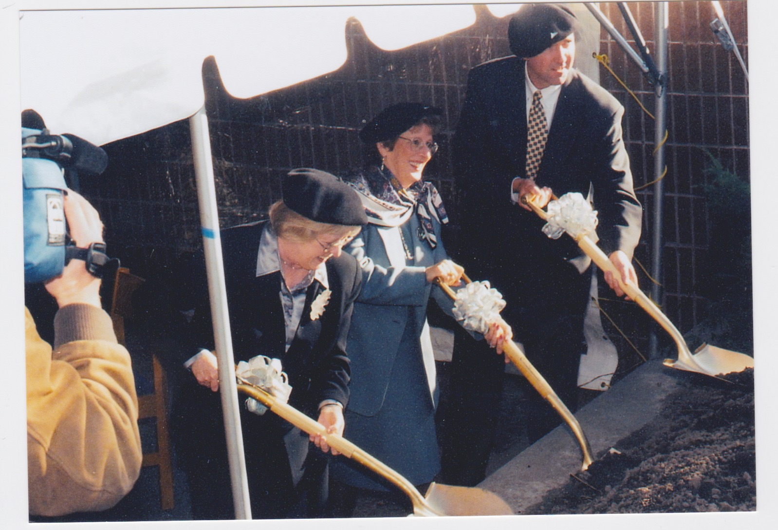 Groundbreaking at the Grimshaw-Gudewicz Art Gallery. Dignitaries sporting artist berets are using shovels.