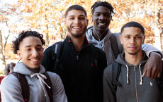 four male students smiling at camera
