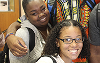 two students smiling at camera